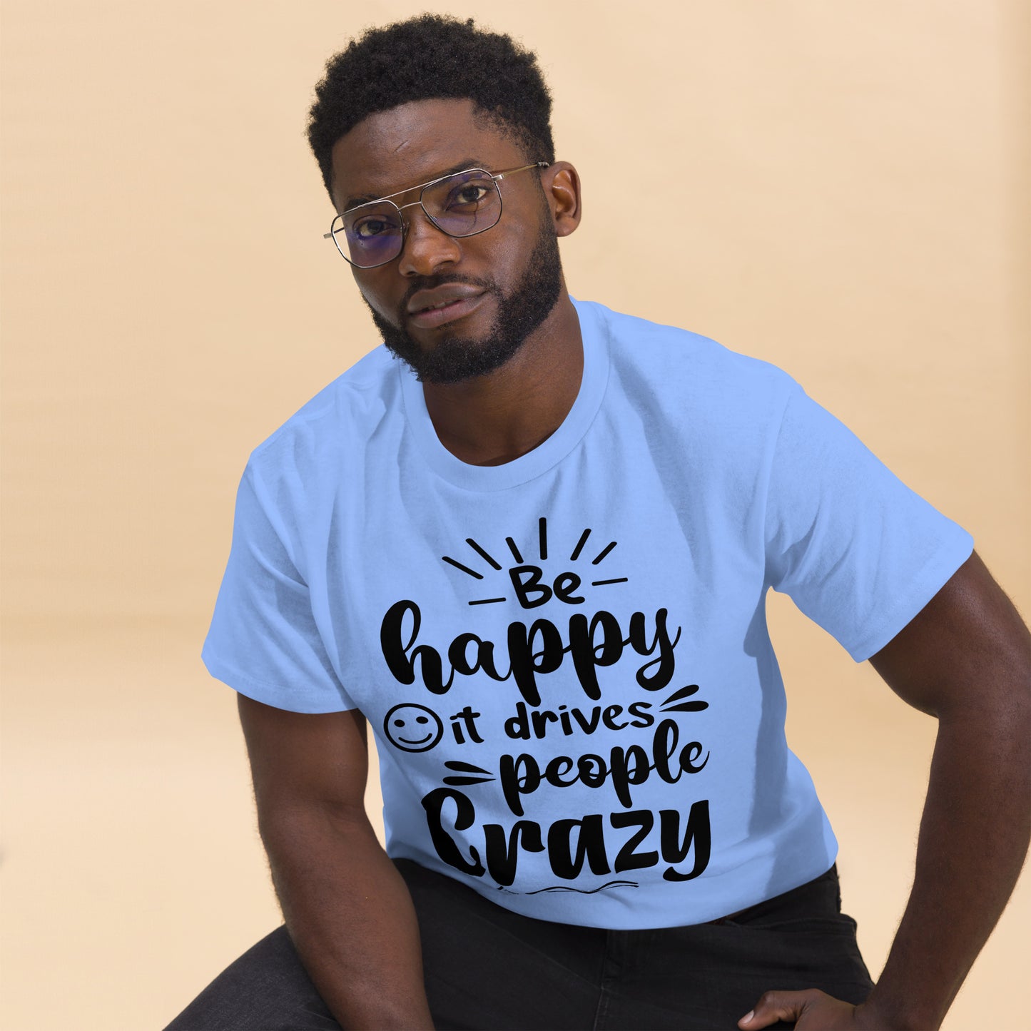Unisex inspirational t-shirt with “Be Happy, It Drives People Crazy” quote in bold typography – Hipyfi Clothes & Design graphic tee. carolina-blue-front
