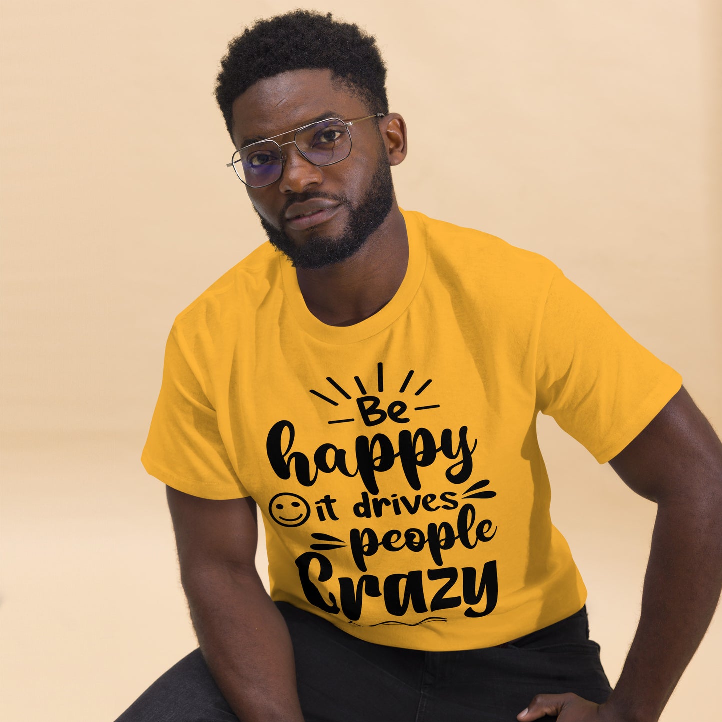Unisex inspirational t-shirt with “Be Happy, It Drives People Crazy” quote in bold typography – Hipyfi Clothes & Design graphic tee. gold-front