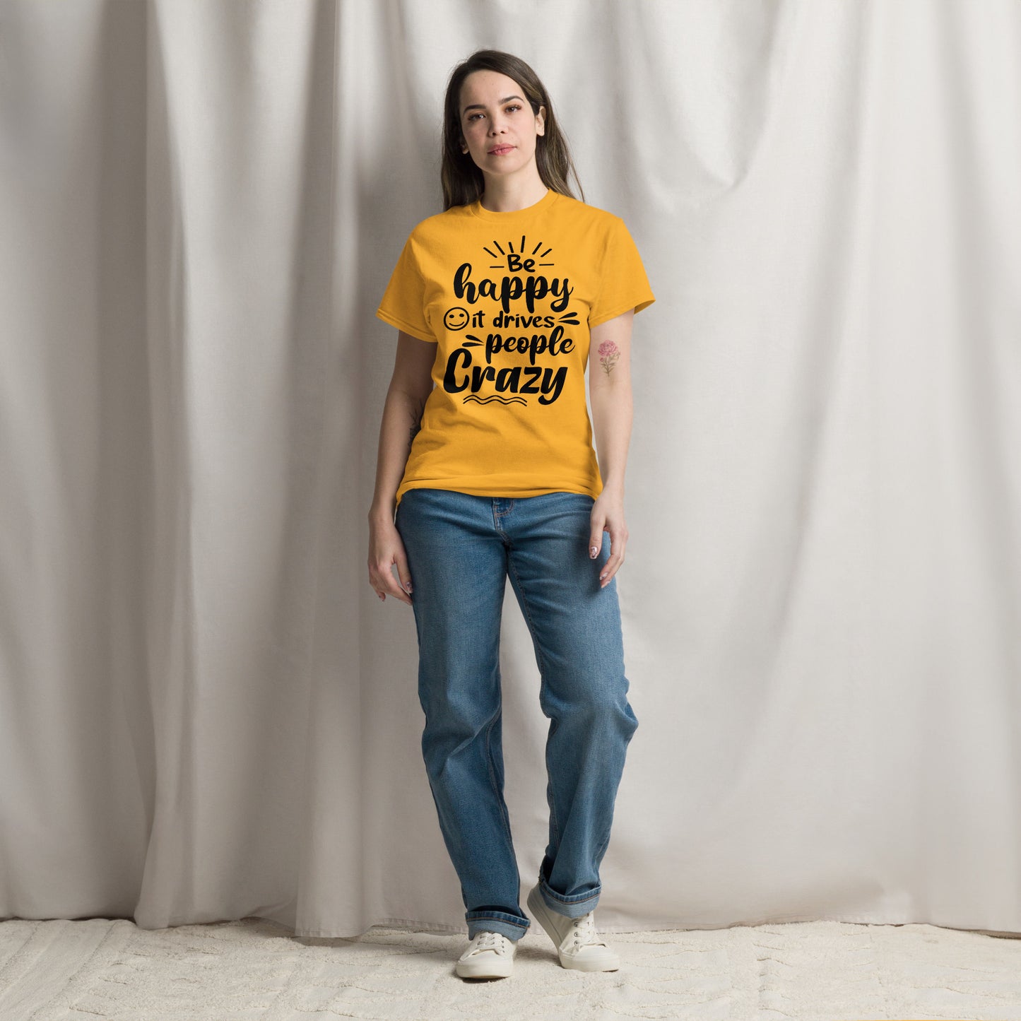 Unisex inspirational t-shirt with “Be Happy, It Drives People Crazy” quote in bold typography – Hipyfi Clothes & Design graphic tee. gold-front-2
