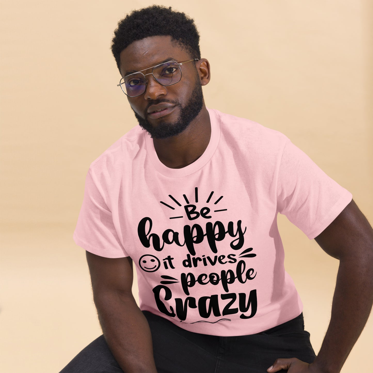 Unisex inspirational t-shirt with “Be Happy, It Drives People Crazy” quote in bold typography – Hipyfi Clothes & Design graphic tee. light-pink-front