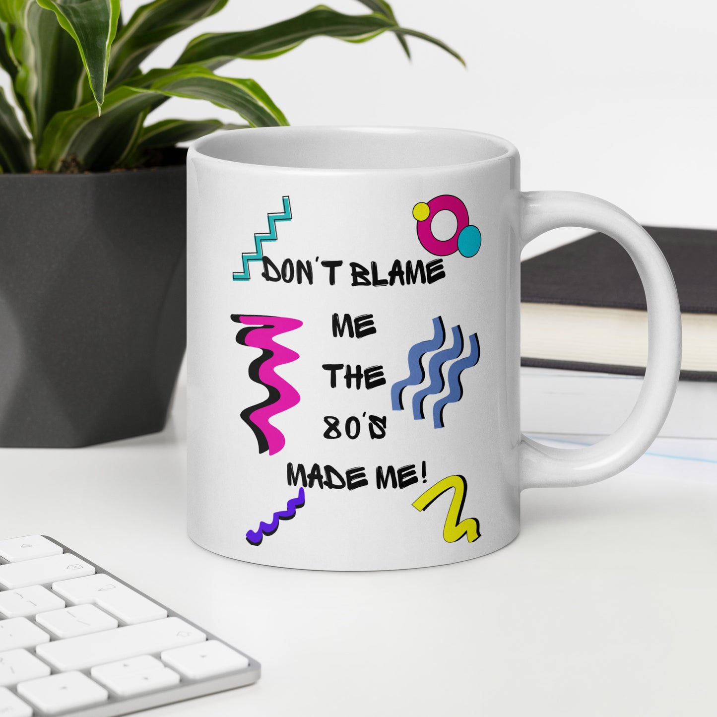 Retro 80s ceramic mug with colorful abstract design and ‘Don’t Blame Me, The 80s Made Me!’ quote by Hipyfi Clothes & Design 20-oz-office-environment