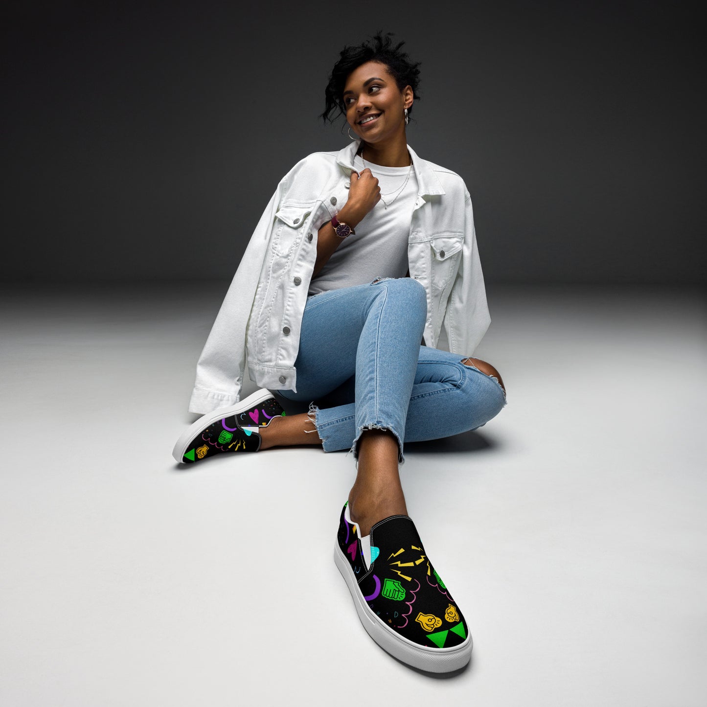 Women's Retro Canvas Slip-On Sneakers with vibrant 80s Memphis-style abstract pattern on black background – stylish, lightweight, and eco-friendly casual shoes by Hipyfi Clothes & Design. white-front