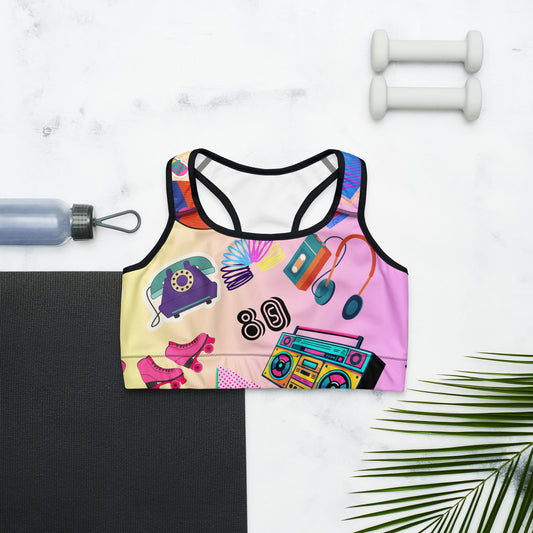 Retro 80s women’s sports bra with vibrant vintage pop culture design, ideal for workouts and casual wear. Black-front
