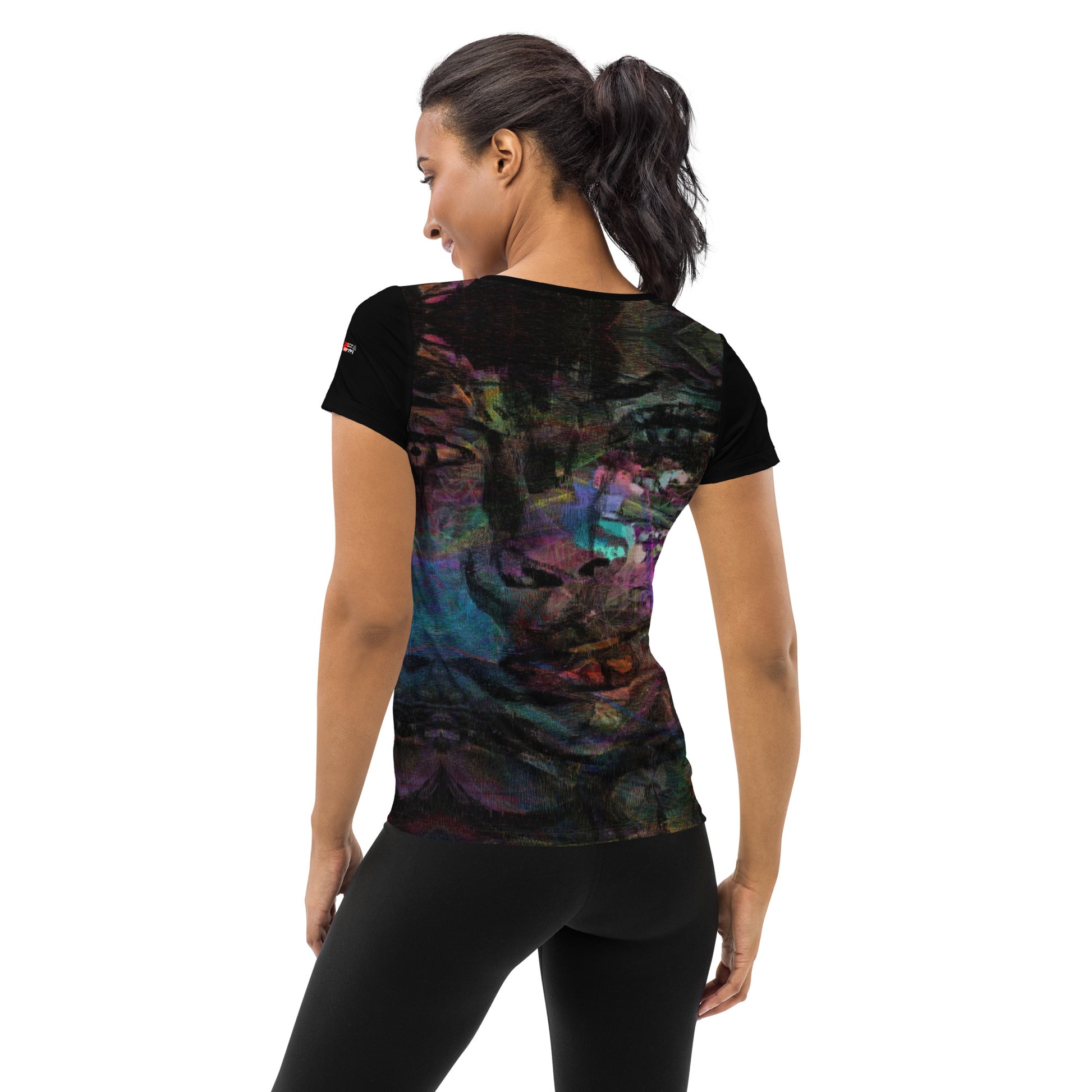 A woman in a vibrant Hipyfi Chromatic Dreams Athletic Tee. The artistic pattern blends, while the lightweight and performance-ready fit. back