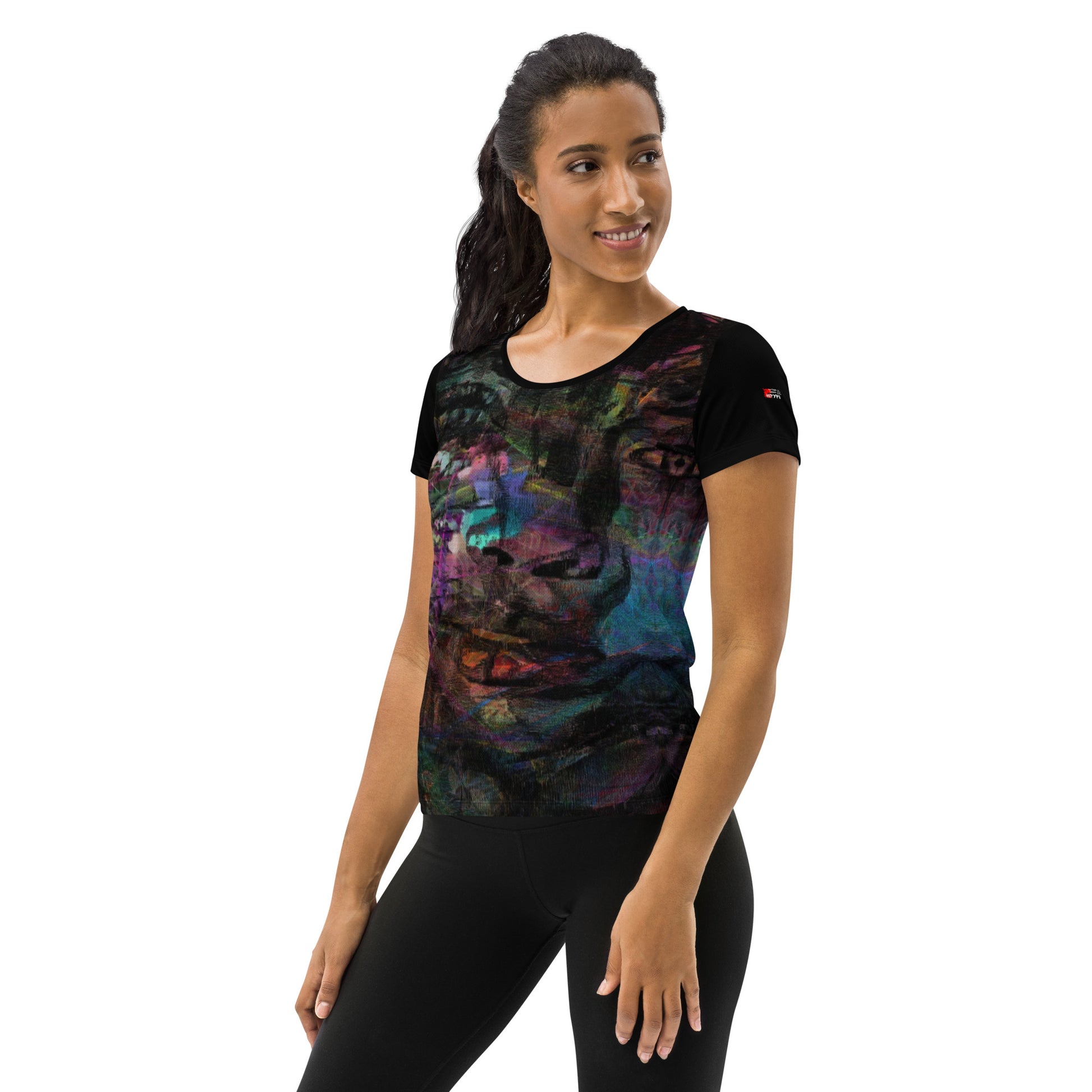 A woman in a vibrant Hipyfi Chromatic Dreams Athletic Tee. The artistic pattern blends, while the lightweight and performance-ready fit. left