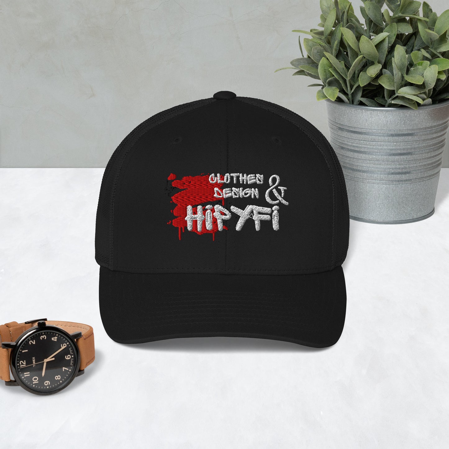 Black Hipyfi Classic Logo Trucker Cap with embroidered front, mesh back, and adjustable snapback closure. Front-2