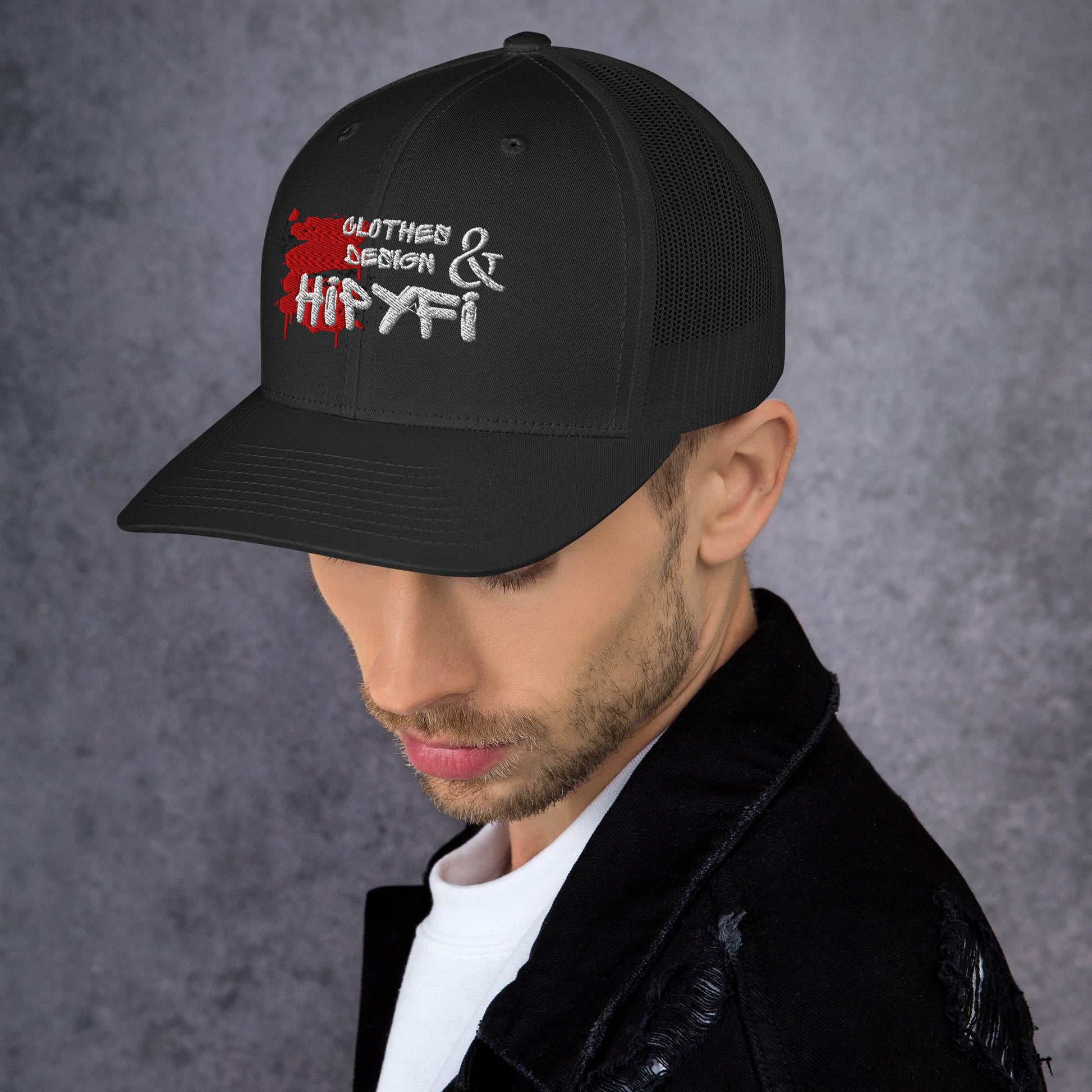 Black Hipyfi Classic Logo Trucker Cap with embroidered front, mesh back, and adjustable snapback closure. Left