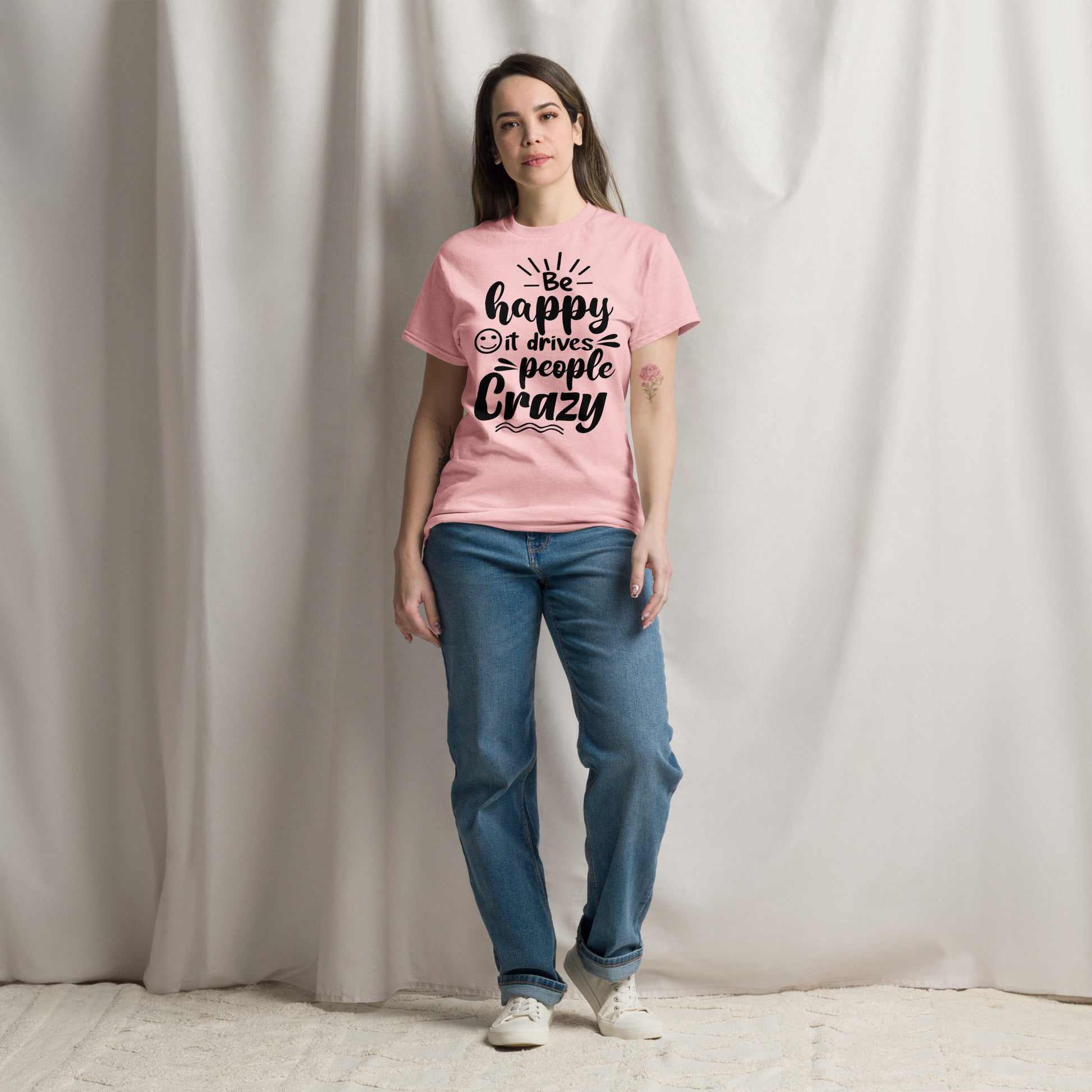 Unisex inspirational t-shirt with “Be Happy, It Drives People Crazy” quote in bold typography – Hipyfi Clothes & Design graphic tee. light-pink-front-2